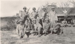 A break during training in the Mojave. George Lambert kneeling in front row at far right of viewer